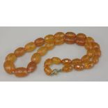 A graduated amber faceted olive bead necklace, 23.5g