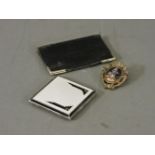 An Art Deco silver and enamel cigarette case, silver mounted wallet, and brooch