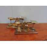 An S Mordan & Co set of Victorian postal scales, circa 1870, brass balance and on an oak base,