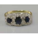 An 18ct gold sapphire and diamond triple cluster ring
