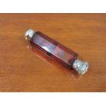 A Victorian cranberry glass double end scent bottle, with silver caps