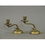 A pair of brass candlesticks, in the manner of Was Benson