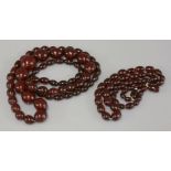 Two rows of graduated olive shaped 'red cherry' bakelite bead necklaces