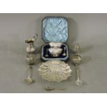 A silver cruet set, with spoons, cased, a silver pierced and embossed scallop shell bonbon dish,