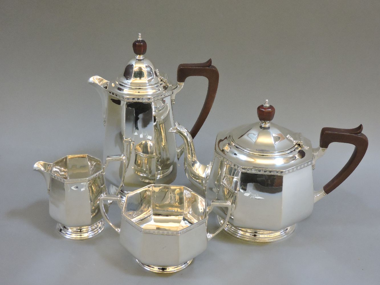 A silver teaset, Birmingham 1927, to include teapot, hot water jug, milk and sugar, all decorated
