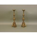 A pair of 17th century style brass pricket candlesticks, 63cm high, together with a coal scuttle and