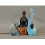 A Vallauris table lamp, modelled as an African lady playing a drum, a Holmegaard glass vase, and a