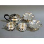 A pair of pierced bonbon dishes, on pedestal, and a silver plated teaset, including teapot, sugar