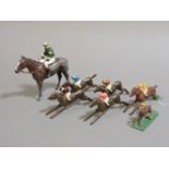 Four lead 'Escalado' racing game horses with jockeys, a lead race horse with jockey up, from