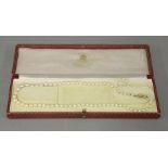 A single row graduated cultured pearl necklace, with gold and split pearl clasp, marked 375