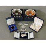 Silver items, two modern coasters, five wine labels, a bottle drip ring, and a caddy spoon
