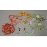 A twig coral necklace, a glass bangle, a hardstone butterfly necklace, a reconstituted coral