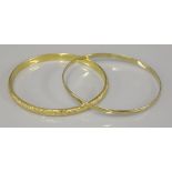 A 9ct gold bangle, and a hollow diamond cut bangle, tested as approximately 18ct gold