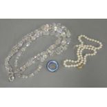 A single row uniform cultured pearl necklace, with a two colour 9ct gold clasp, a three row