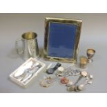 A collection of wristwatches and silver plated items, including souvenir spoons