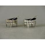 A pair of Victorian silver boat shaped salts, pierced, with blue glass liners, and a pair of