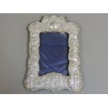 A silver repoussé decorated photograph frame, decorated with insignia relating to the second Boer