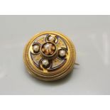 A Victorian gold Etruscan revival brooch, set with an enamel Celtic cross and split pearls