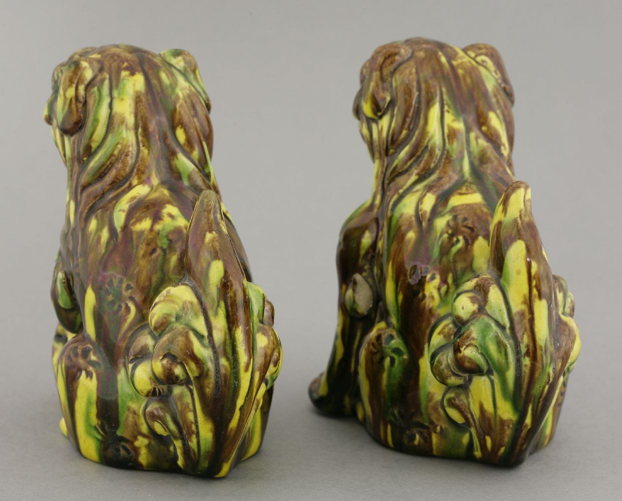 A pair of earthenware sancai Buddhist lions, circa 1880, each crouching over a pierced ball, its - Image 3 of 5