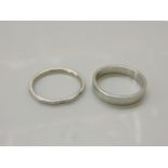 Two platinum wedding rings, including a flat faceted example, 9.15g