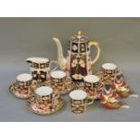 A Royal Crown Derby Imari pattern coffee pot, 2451, damaged, with six coffee cans, five coffee