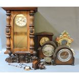 A mahogany inlaid mantel clock, a Vienna regulator style wall clock, and three other mantel clocks
