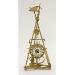 A gilt metal nautical themed clock, the timepiece in a ship's wheel and anchor mount, suspended from