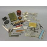 A collection of items, including lighters, pens, geometry instruments, set of six '800' teaspoons,