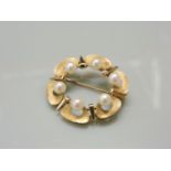 A Continental cultured pearl gold circle brooch, with outer lobes and Florentine decoration marked