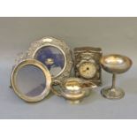 Two silver mounted picture frames, a silver faced child's clock, a silver champagne cup, and a