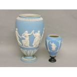 A Wedgwood Jasper ware urn, with a frieze of ladies dancing, 26.5cm high, and another, fixed wood