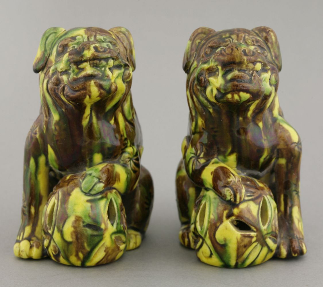 A pair of earthenware sancai Buddhist lions, circa 1880, each crouching over a pierced ball, its - Image 4 of 5