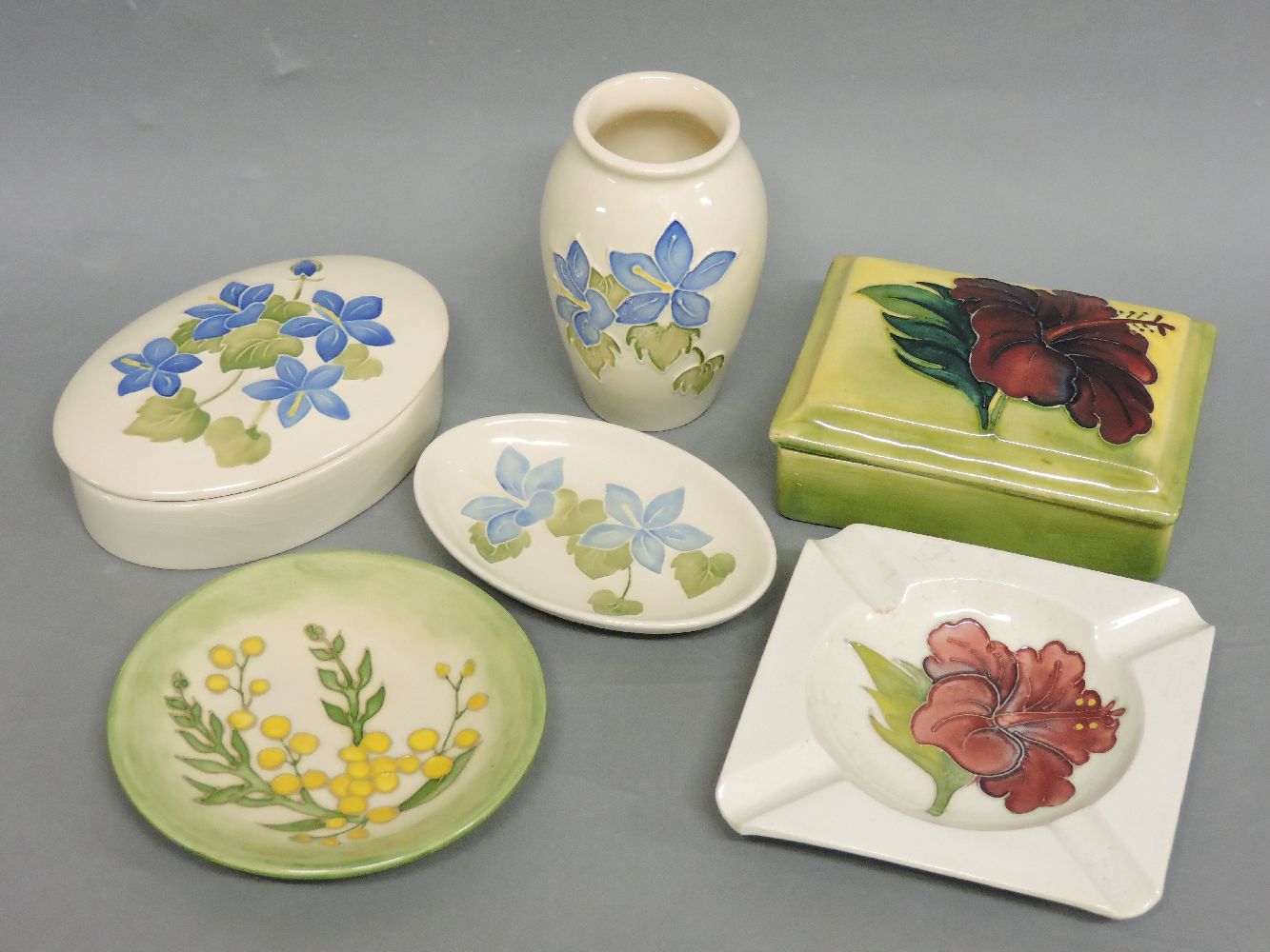 Three Moorcroft items, with blue flowers, a vase, an oval dish and an oval dish and cover, a