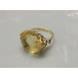 A single stone citrine ring, with open flower shoulders, stamped 9ct