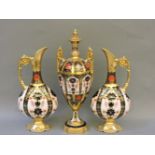 A Royal Crown Derby Imari patterned twin handled urn, damaged, and a pair of Royal Crown Derby ewers