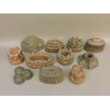 Eleven copper jelly moulds, some marked Benham & Froud