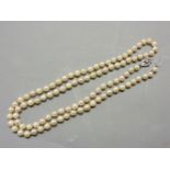 A single row uniform cultured pearl necklace, with a 9ct white gold and diamond set clasp
