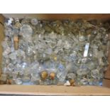 A large quantity of cut glass decanter and bottle stoppers