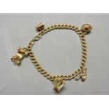 An 18ct gold curb chain bracelet, with four 9ct gold charms, and one tested as approximately 9ct