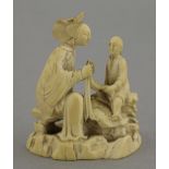A rare ivory group, circa 1800, of a mother, her hair elaborately dressed, seated on a rock, with