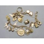 A gold charm bracelet, with various gold charms, stamped 9ct, including a heart locket signet