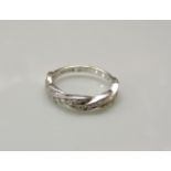 An 18ct white gold diamond set twisted ribbon half eternity ring