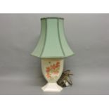 A Moorcroft lamp base, with pink flowers, on a cream ground, and a green shade