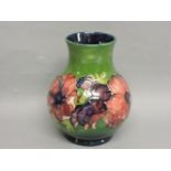 A Moorcroft 'Clematis' vase, with a green ground, blue interior, 23.5cm