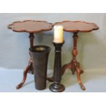 Two reproduction mahogany tripod tables, a turned wooden vase, and candlestick