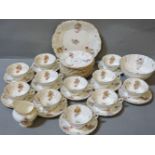 A Coalport part tea service, with gilt and floral decoration, to include ten cups, eleven saucers,