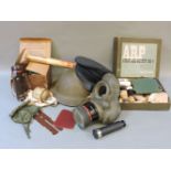 A selection of militaria, to include tin hat, peaked cap, army 15506 gas mask, ARP medical kit, etc