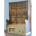 A 19th century curved elm bacon settle, with rear cupboards and two base drawers, 130cm wide,