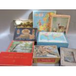 A collection of old jigsaw puzzles, including an official Festival of Britain souvenir puzzle