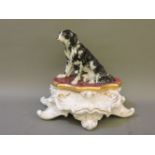 A French porcelain desk stand, the cover modelled as a hound, over three wells, on a scrolled